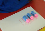 Three trains of coloured cubes, each train with two blue cubes and one pink, aligned with the pink cube at the top in all trains.